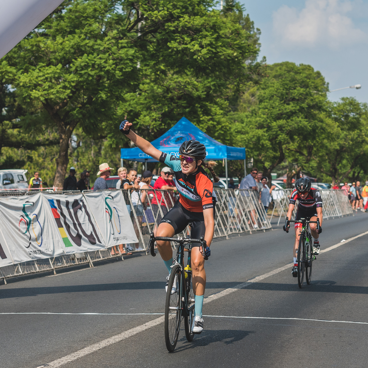 Pro cyclist Tiffany Keep celebrating victory at finish line